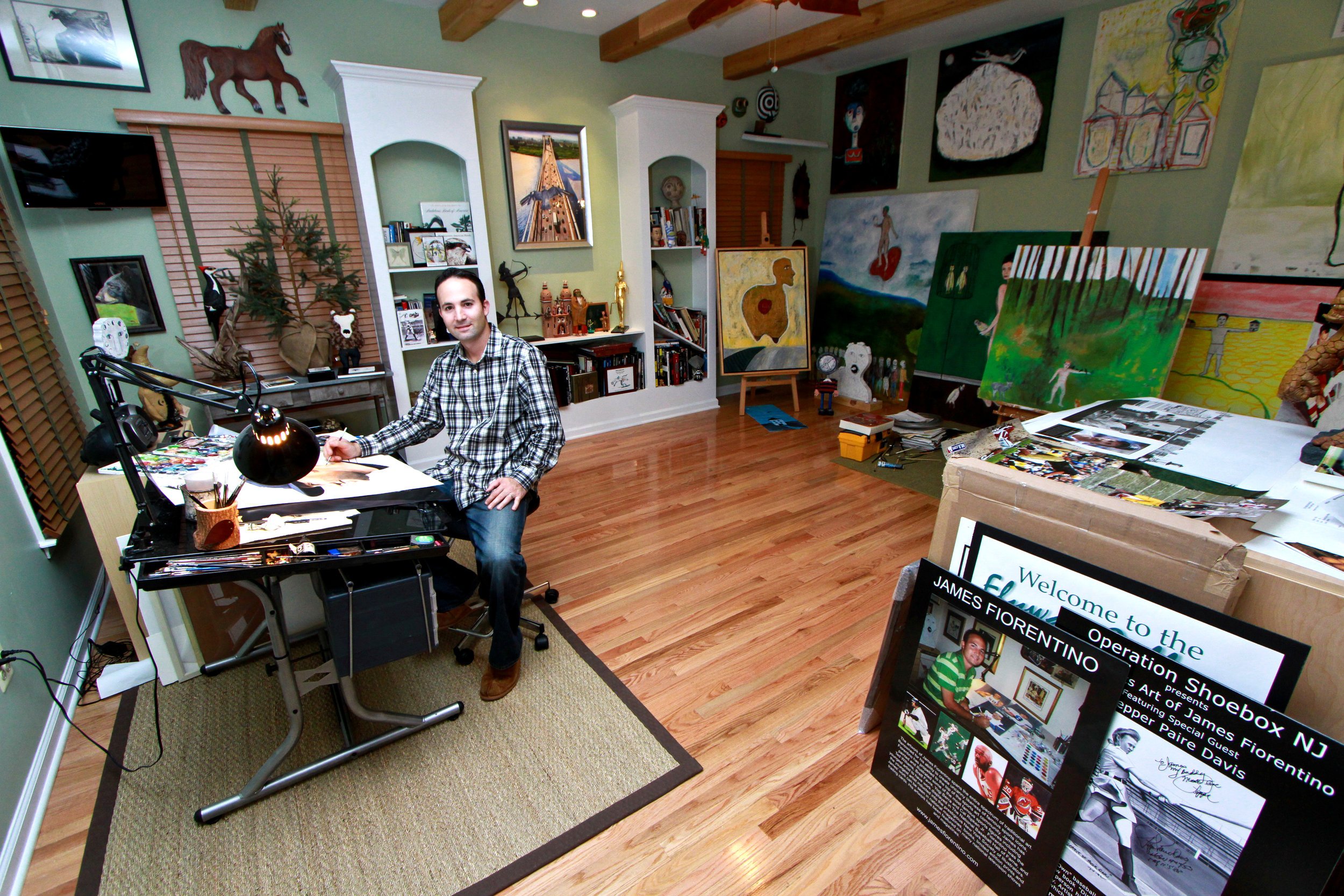 a man sitting at a desk in a room.
